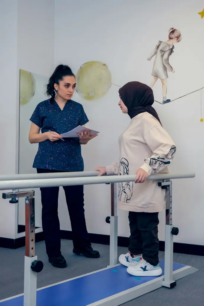 a woman standing next to a woman on a treadmill